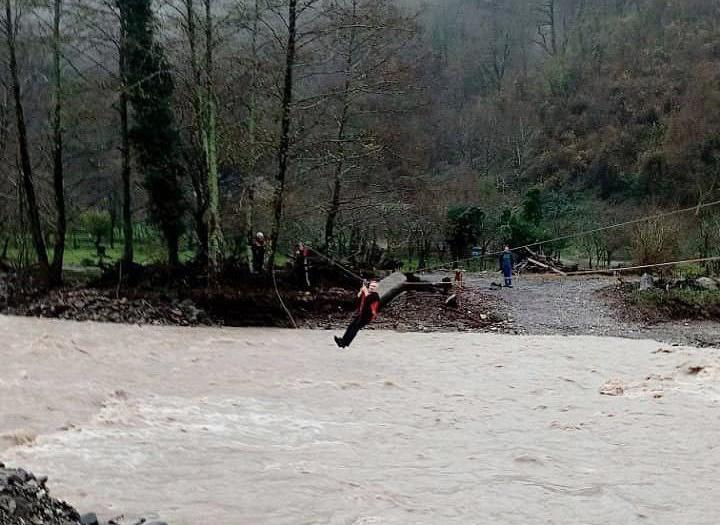 Сочинские спасатели помогают жителям перебираться через бурную реку