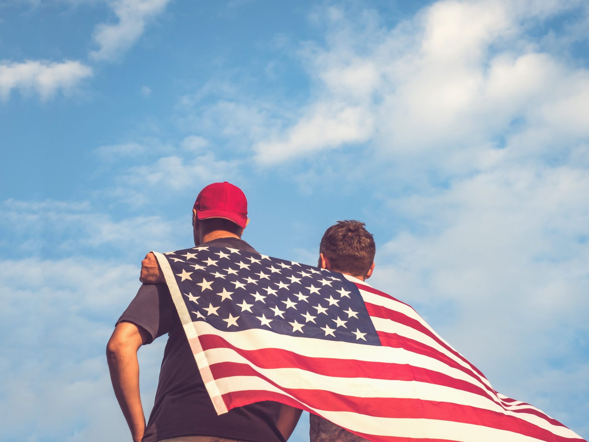 Американцы считают. Gay men holding Flag.