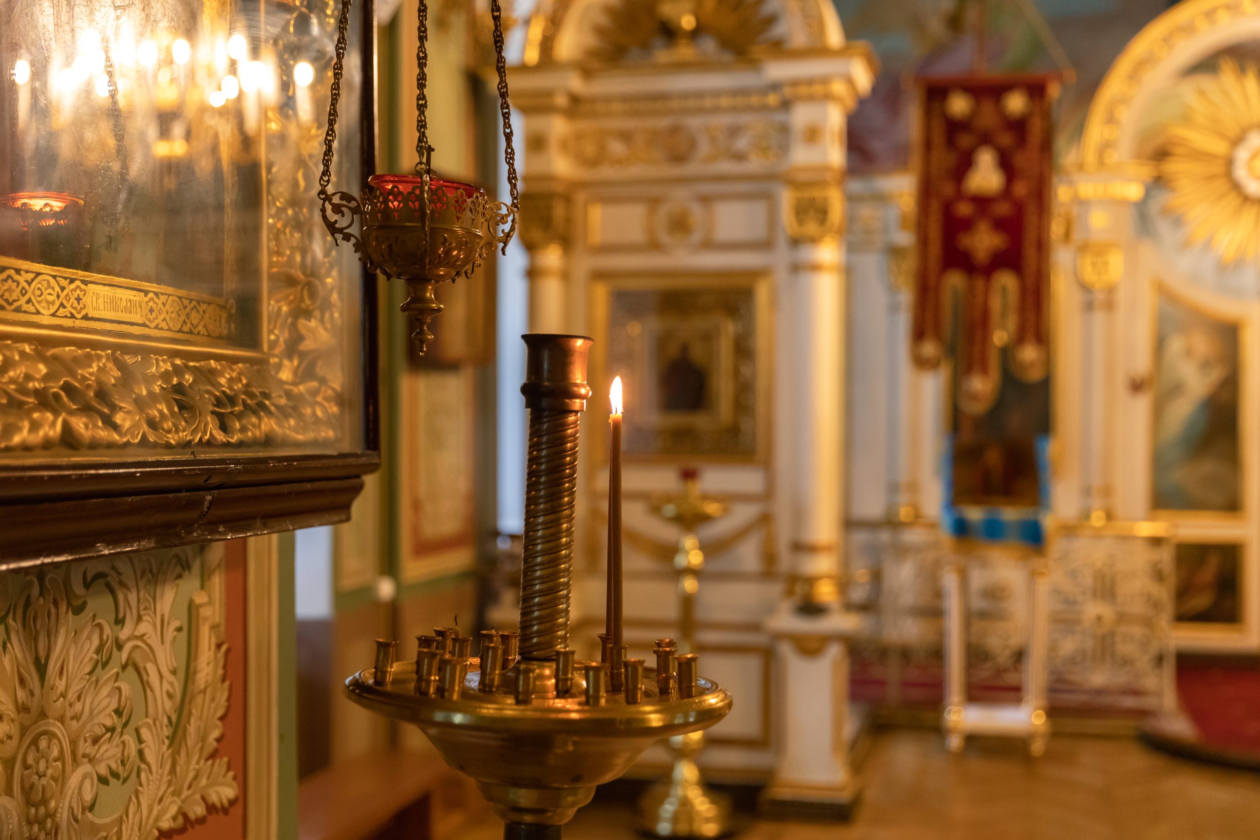 Orthodox Church. Christianity. Festive interior decoration with burning candles and icon in traditional Orthodox Church on Easter Eve or Christmas. Religion faith pray symbol