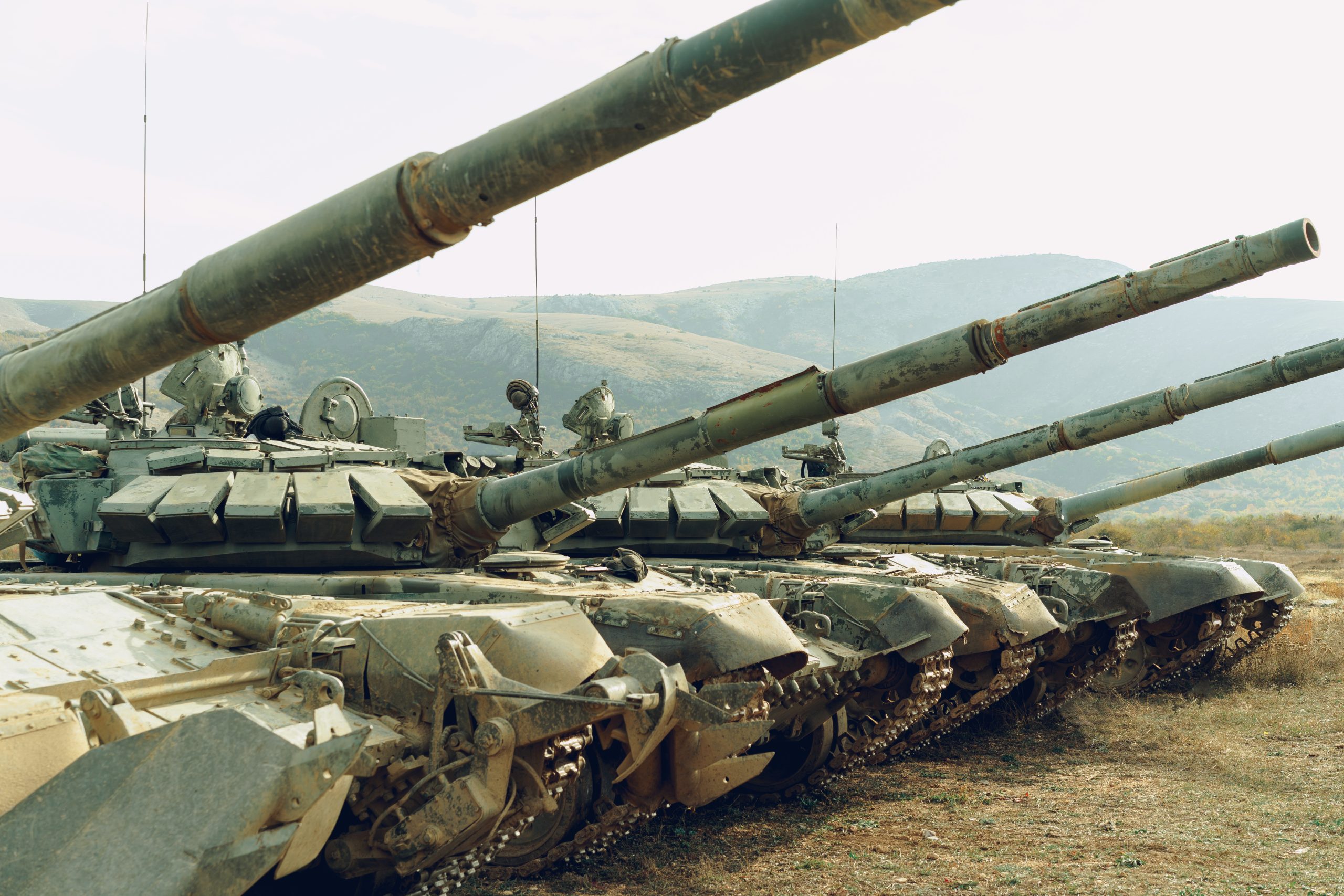 Dirty Russian battle tanks at tankodrome in mountains