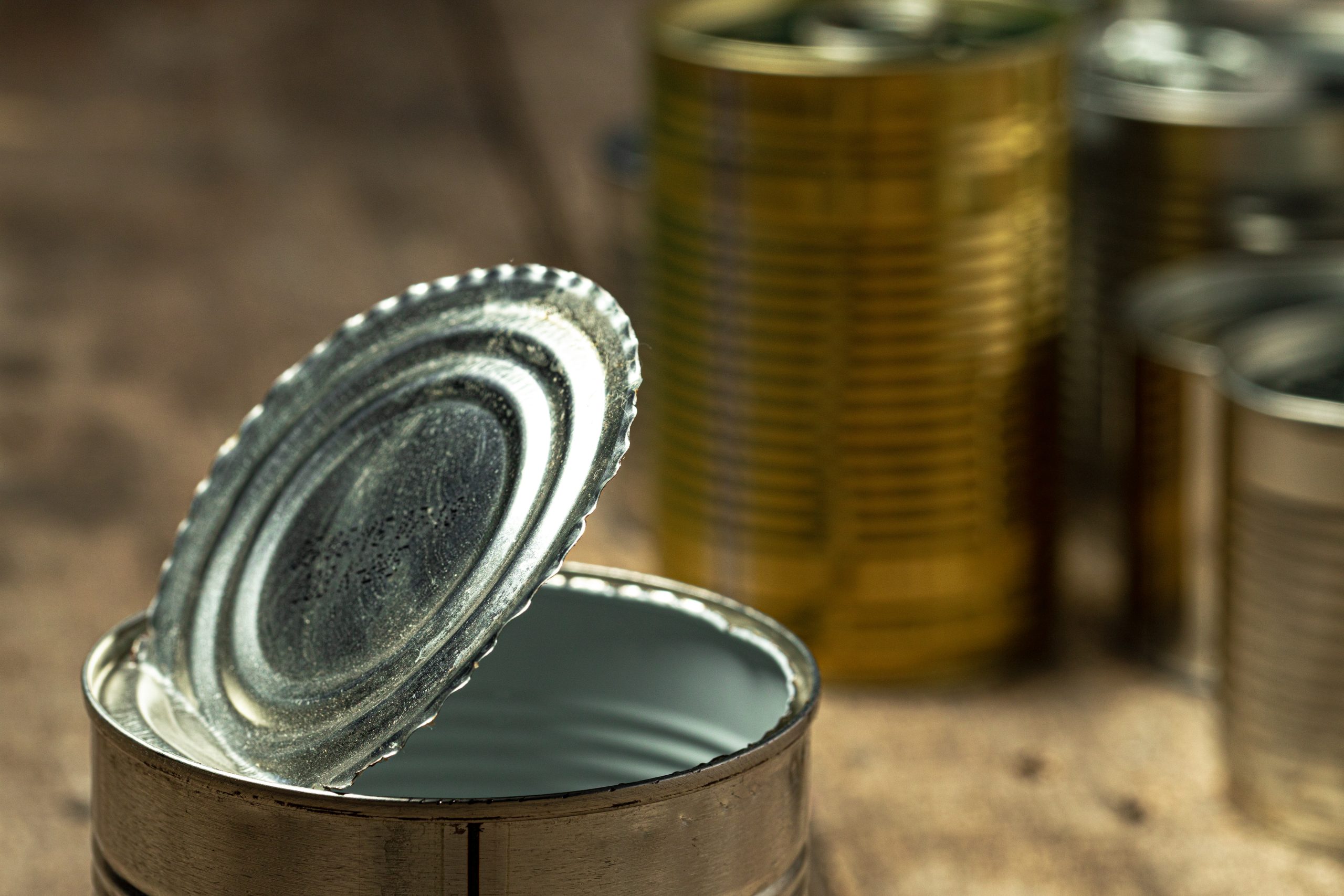 Tin cans with food on the table. Close up.
