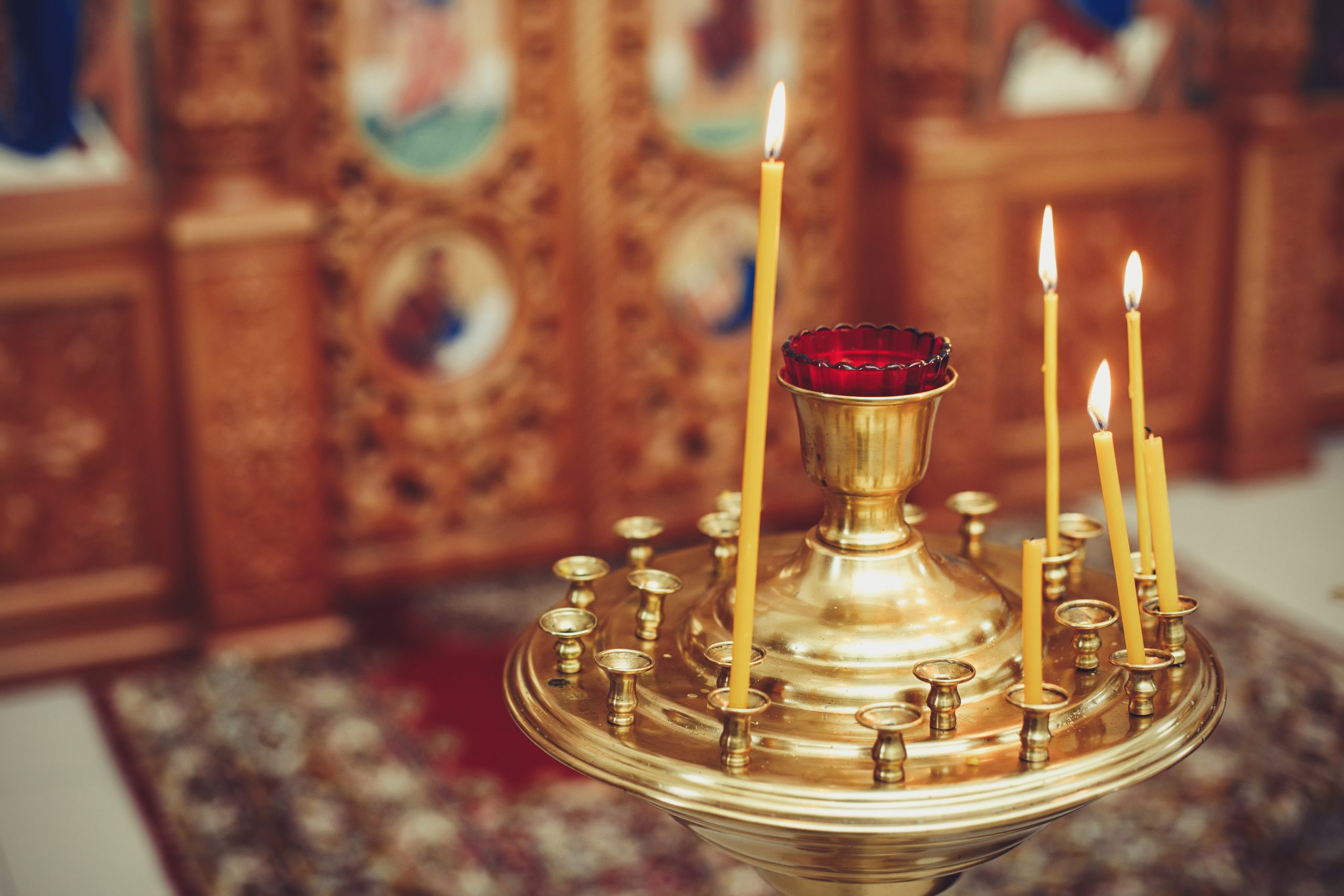 The candle flame in orthodox church, selective focus, close up