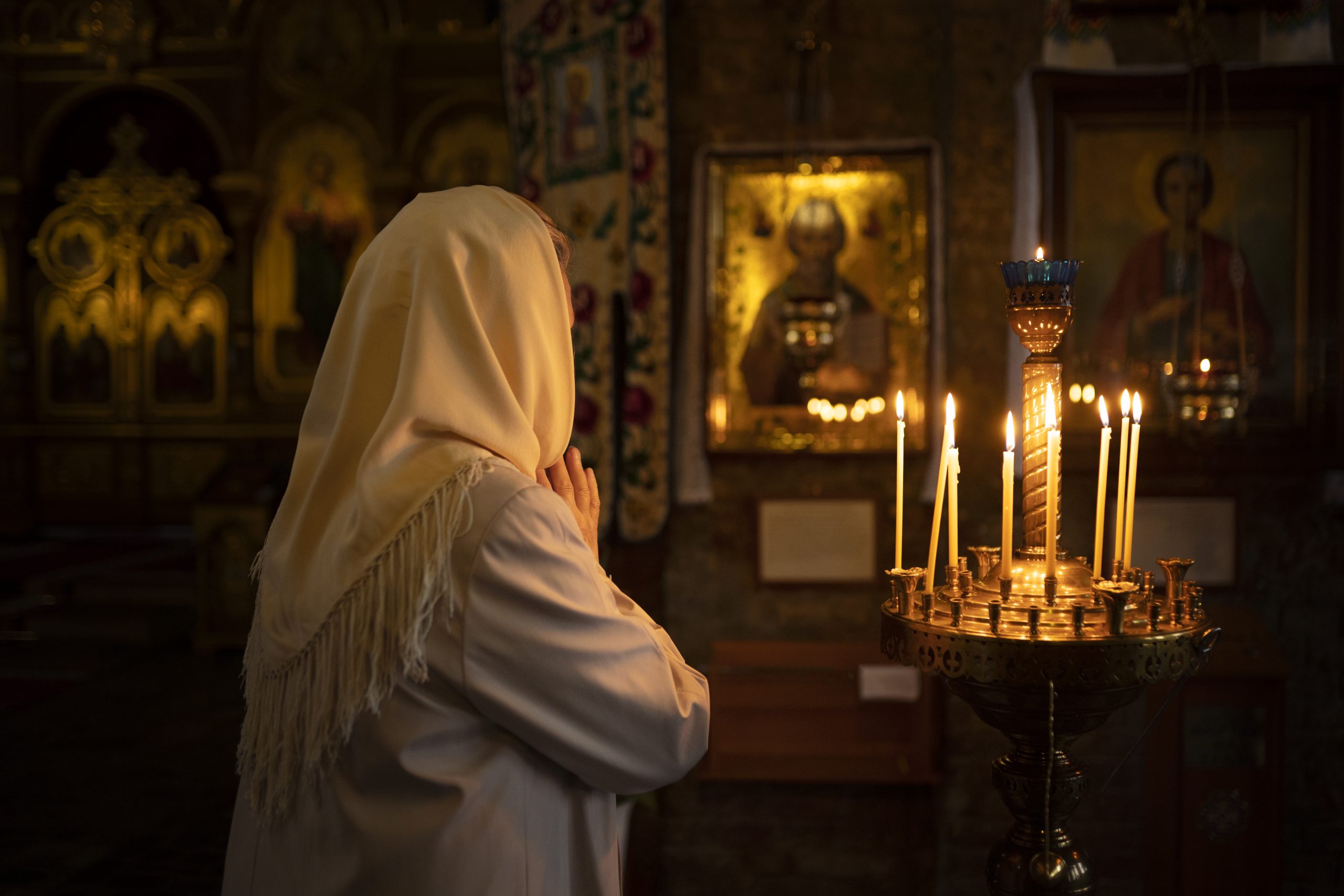 people-lighting-candles-church-celebration-greek-easter