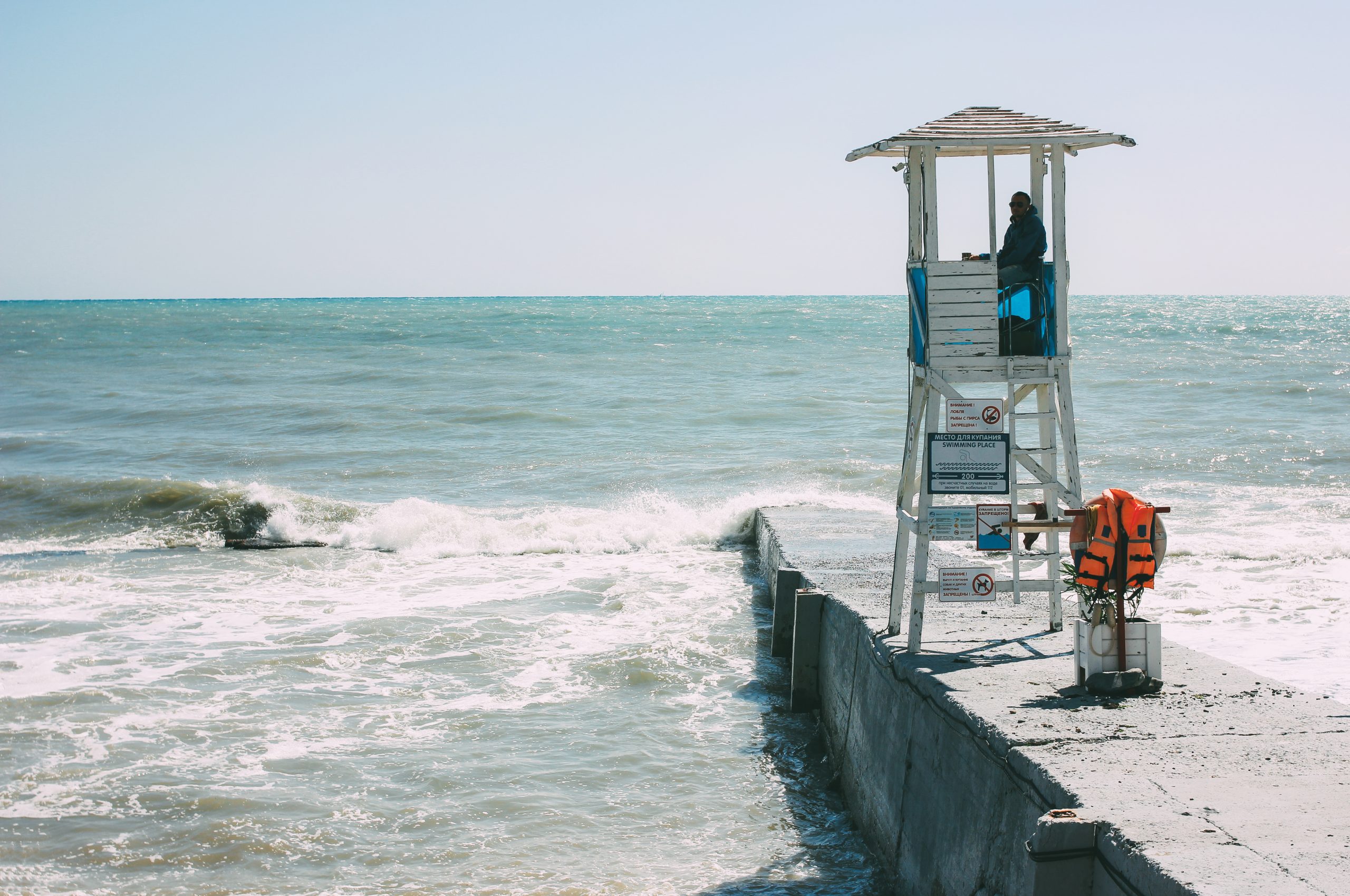 White booth tower with lifeguard on the shore of storming Black sea, empty beach